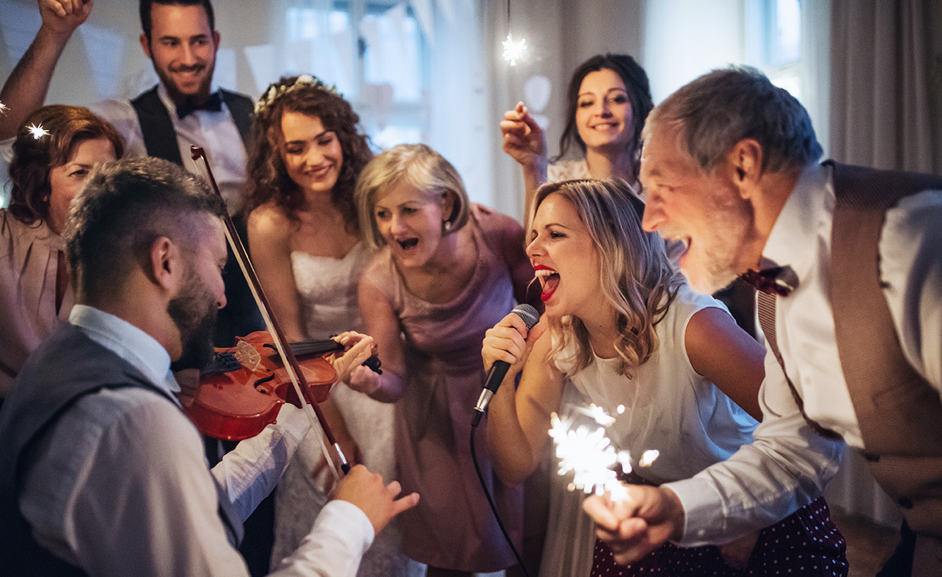 Wedding guest experience singing with band at reception