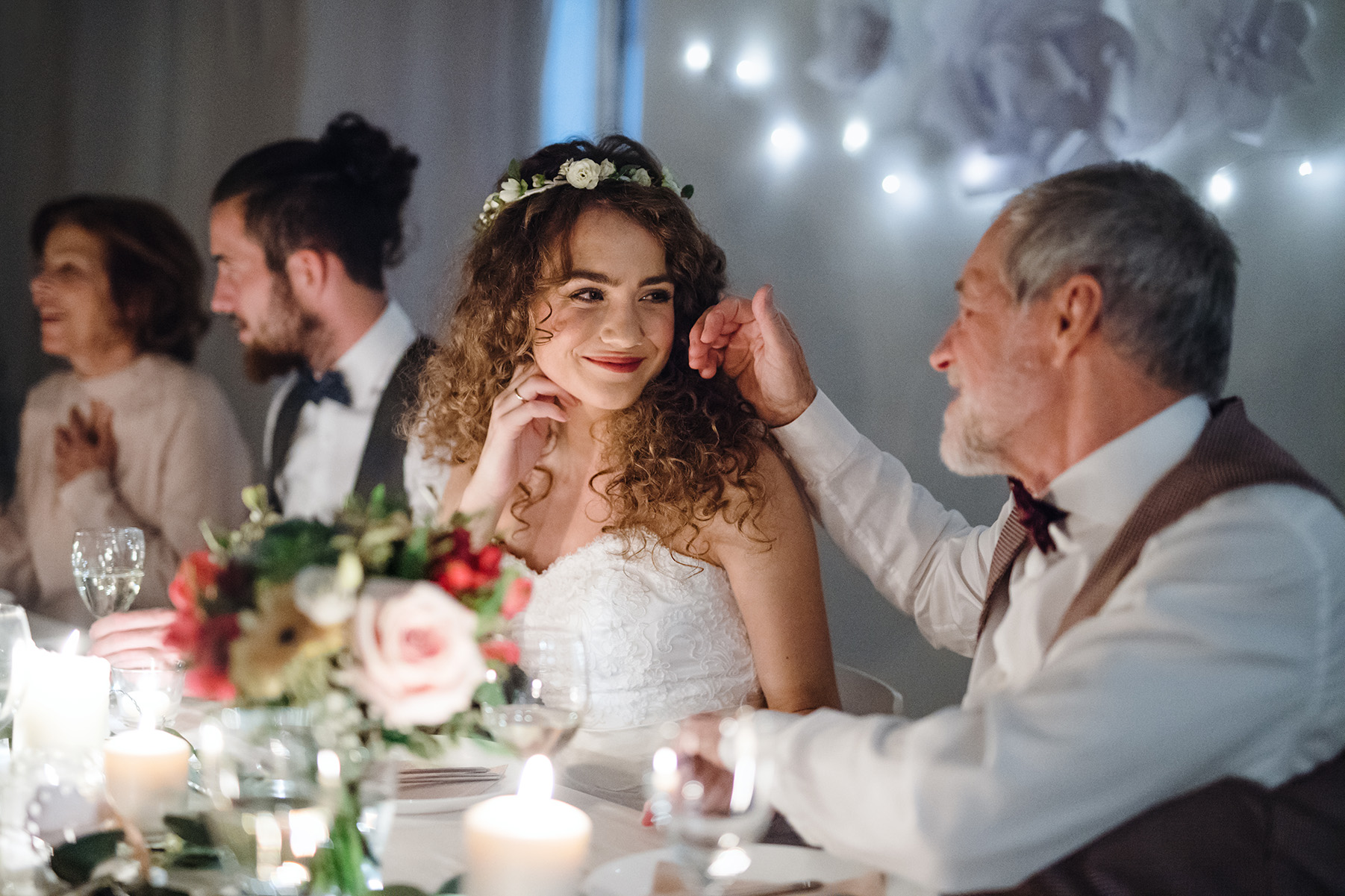 Bride and father smile at each other at wedding reception