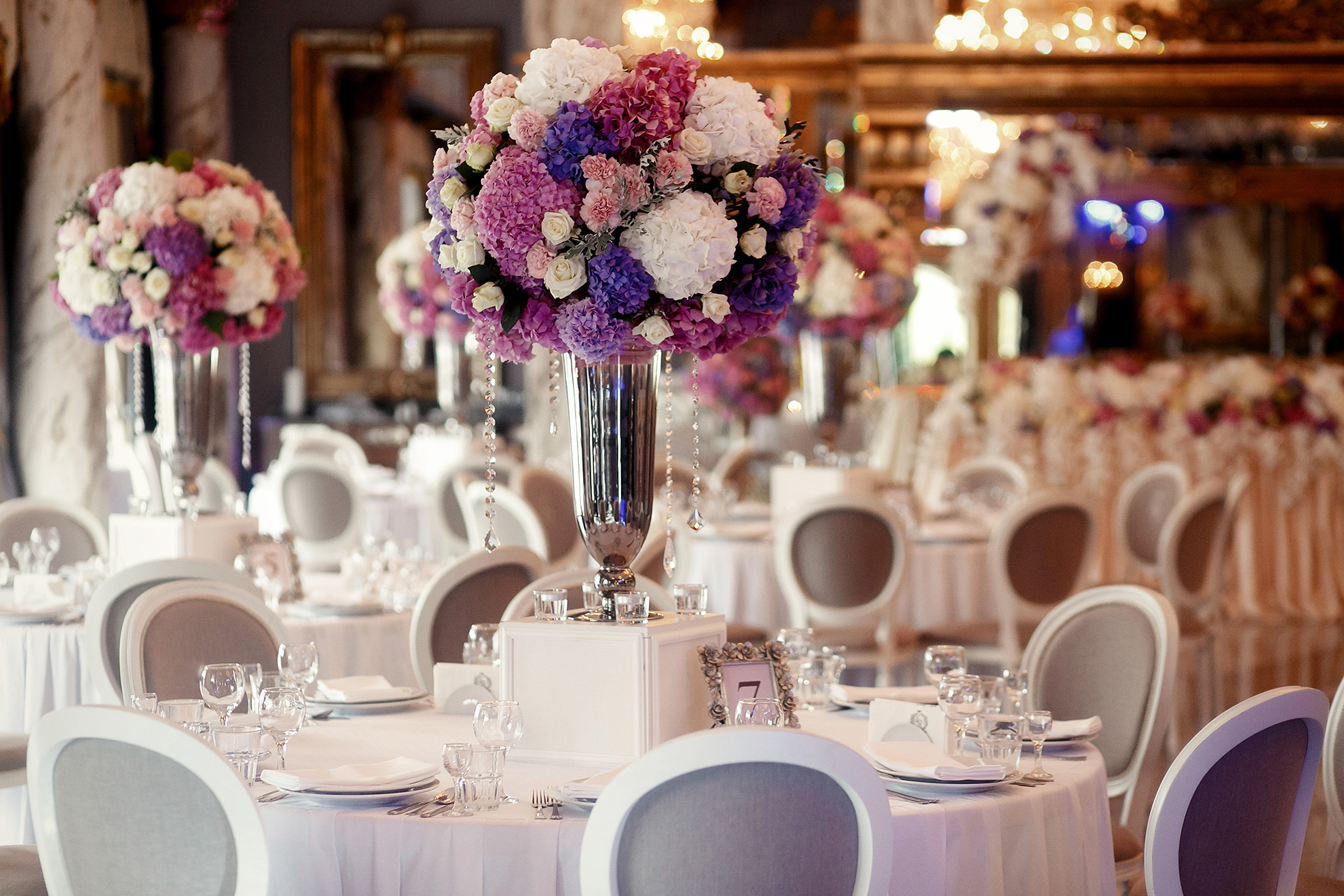 Indoor reception venue decorated with purple and pink